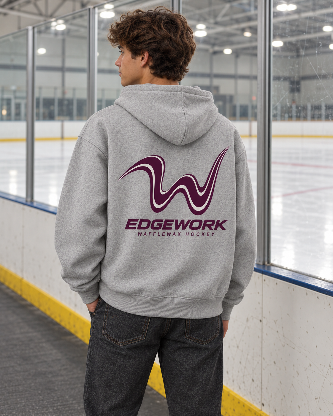 AI-generated mockup of a teen model wearing the athletic grey EDGEWORK hoodie beside an ice rink, showing the plum skate-track back graphic.