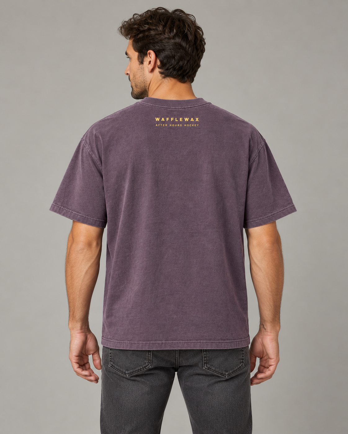 AI-generated back-view mockup of an adult man wearing the faded grape Late Skate Tee with small WaffleWax After Hours Hockey lettering below the collar.