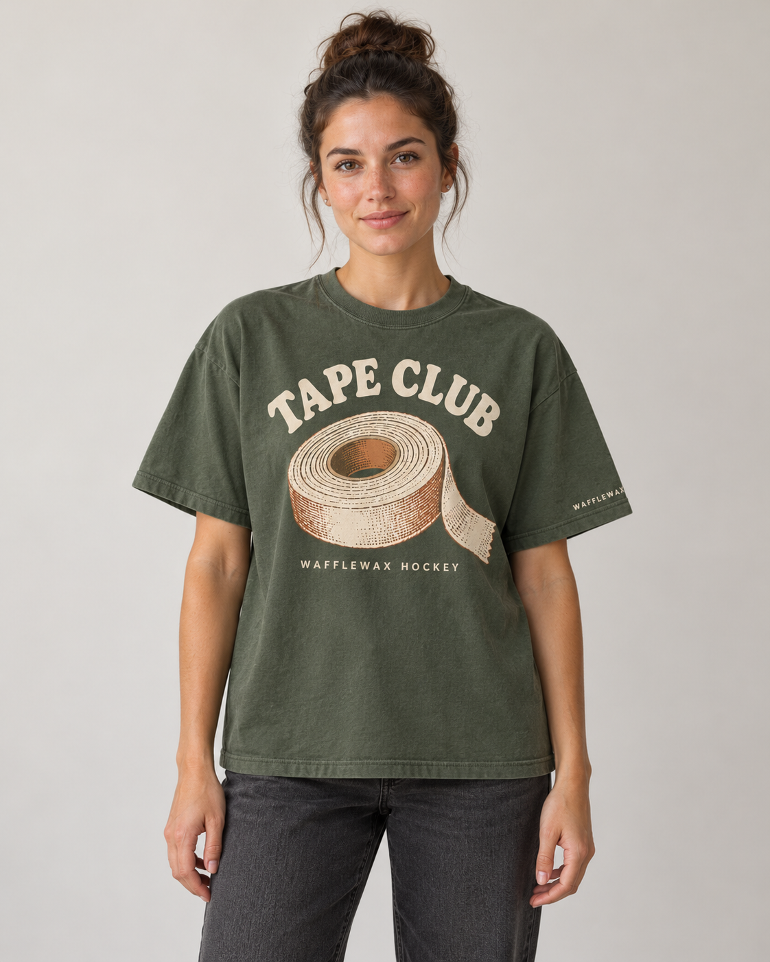 AI-generated mockup of a woman wearing the moss green WaffleWax Hockey Tape Club tee, front view.