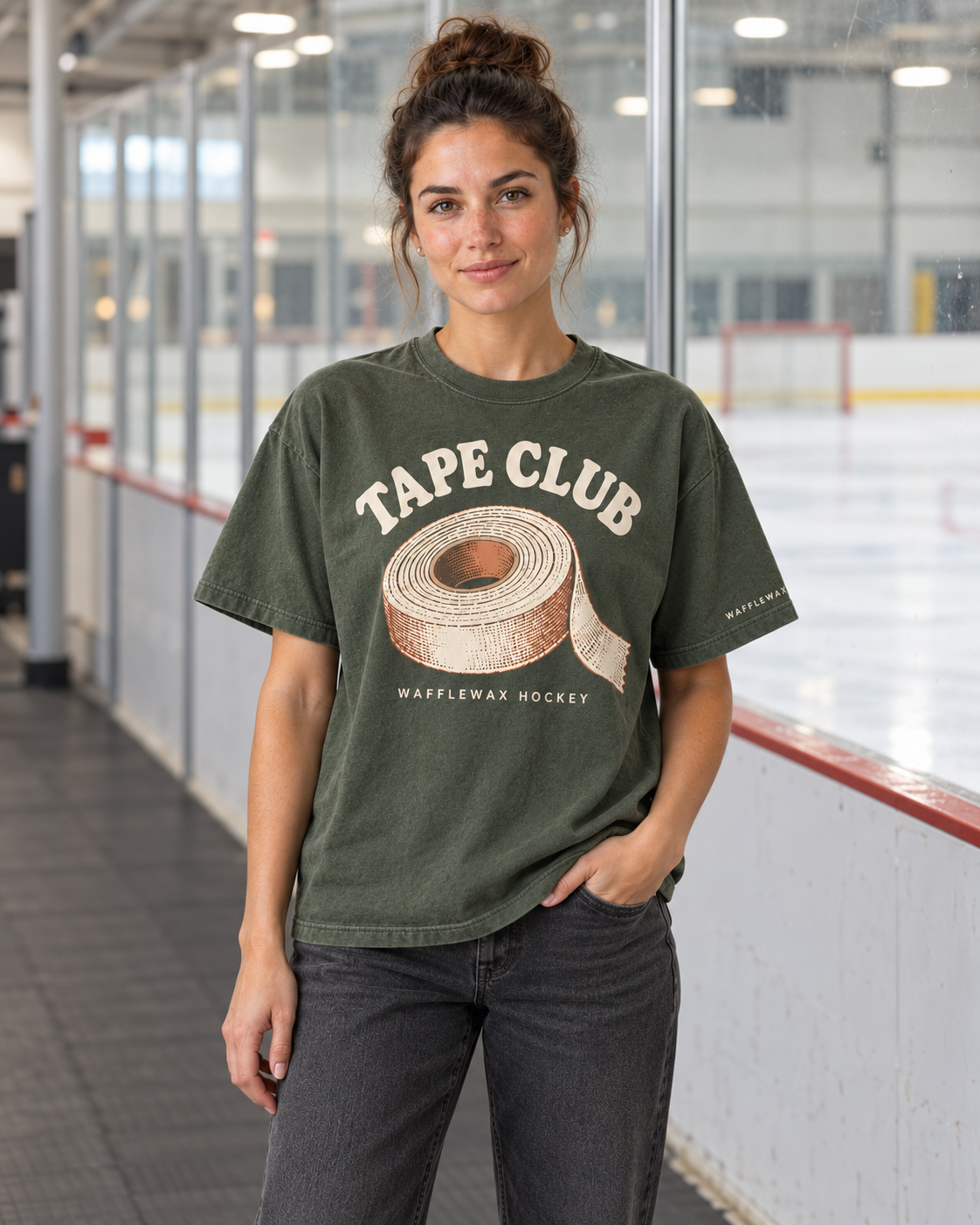 AI-generated lifestyle mockup of a woman wearing the moss green Tape Club tee beside an ice rink.